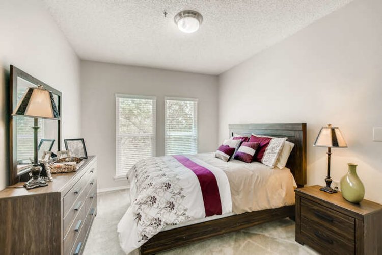 Bedroom With Purple Accents and Wood Furniture at Independent Living Facility Bedroom With Purple Accents and Wood Furniture at Independent Living Facility