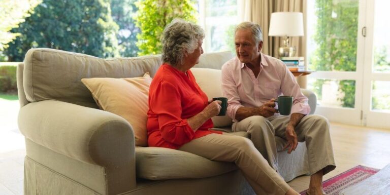 Elderly Couple Having Morning Coffee In Their Assisted Living Apartment