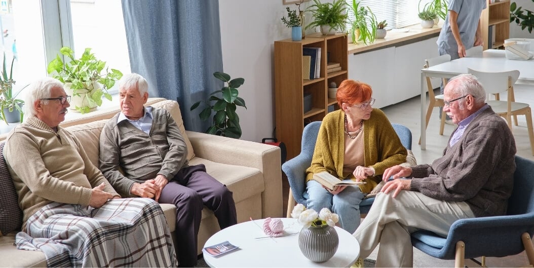 Group of Elderly Residents Socializing in a Common Living Area at an Assisted Living Facility