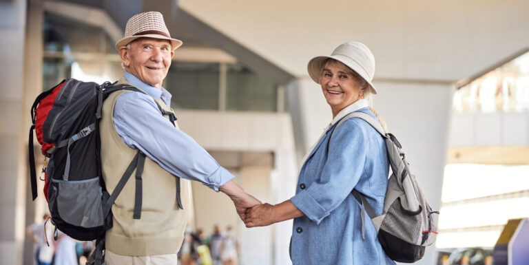 Elderly Couple with Backpacks Holding Hands at an Independent Living Facility