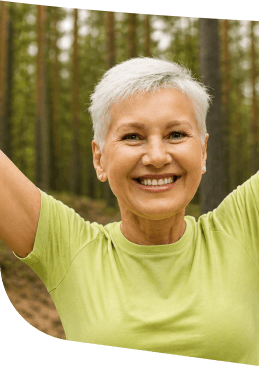 Happy Elderly Woman With Arms Raised in the Forest Near Independent Living Happy Elderly Woman With Arms Raised in the Forest Near Independent Living
