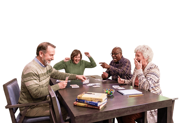 Four Elderly Friends Playing a Lively Card Game at an Independent Living Facility Four Elderly Friends Playing a Lively Card Game at an Independent Living Facility