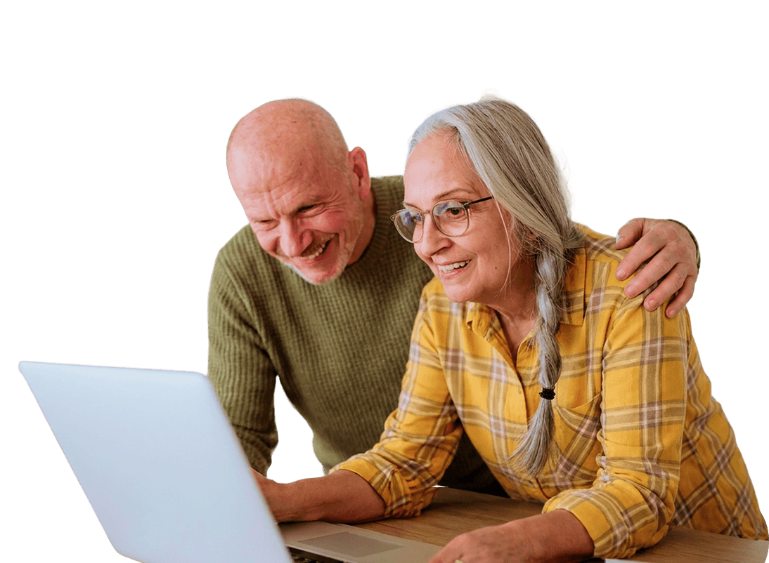 Smiling Elderly Couple Browsing a Laptop Together at an Independent Living Community Smiling Elderly Couple Browsing a Laptop Together at an Independent Living Community