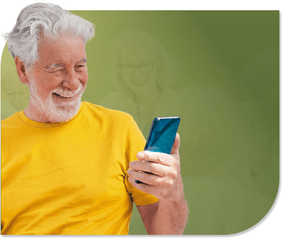Smiling Elderly Man Reading His Smartphone in Independent Living
