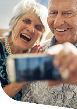 Elderly Woman and Man Taking Cheerful Selfie Together in Independent Living Community Elderly Woman and Man Taking Cheerful Selfie Together in Independent Living Community