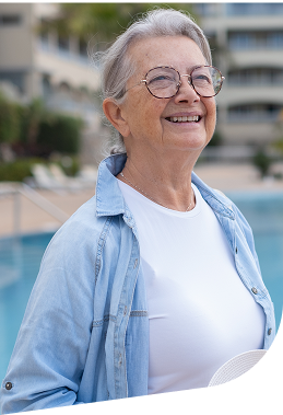 Elderly Woman Smiling Outdoors near Pool at Independent Living Facility Elderly Woman Smiling Outdoors near Pool at Independent Living Facility