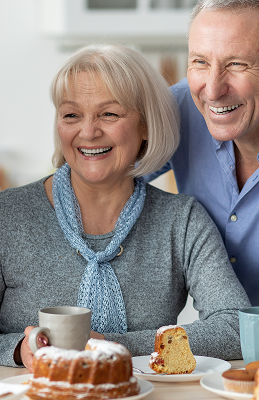 Elderly Couple Enjoying Coffee and Cake Together in Independent Living Elderly Couple Enjoying Coffee and Cake Together in Independent Living