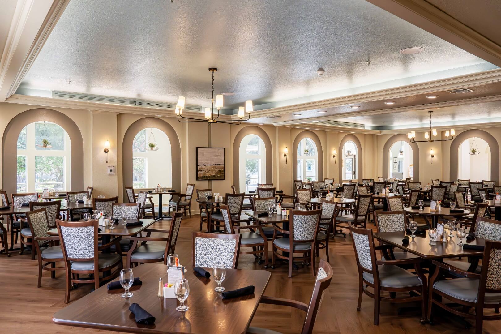 Elegant Dining Room With Arched Windows in an Assisted Living Facility