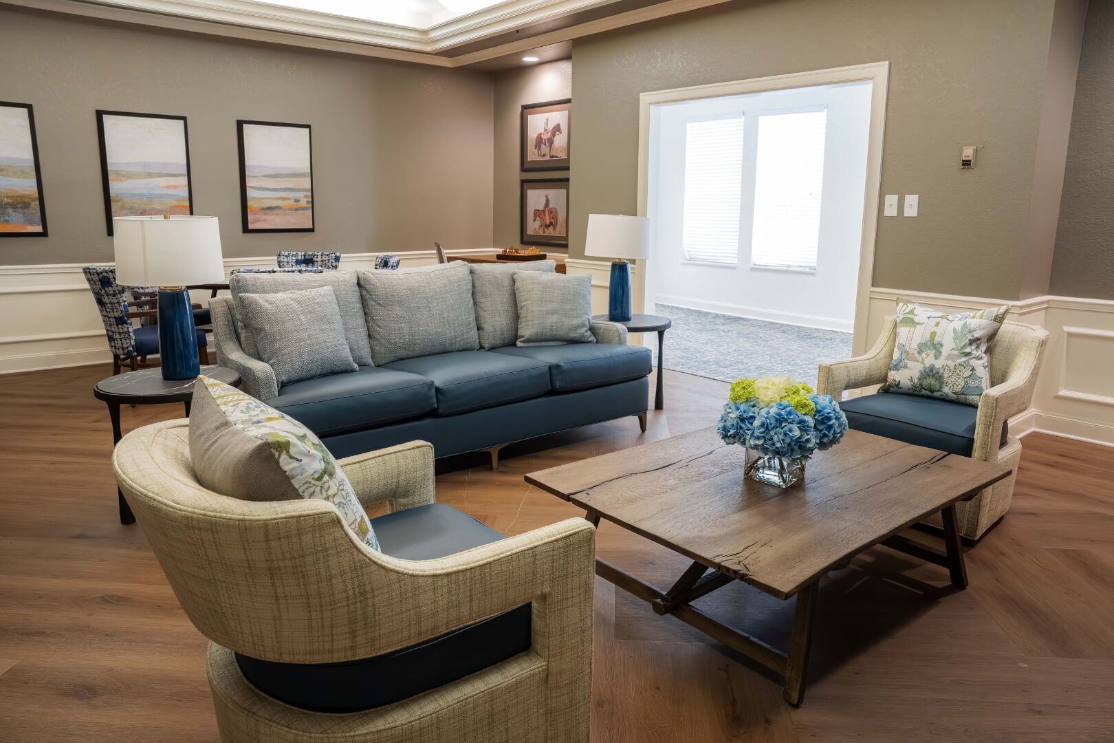 Comfortable Lounge With Sofa and Fresh Flowers at an Independent Living Facility