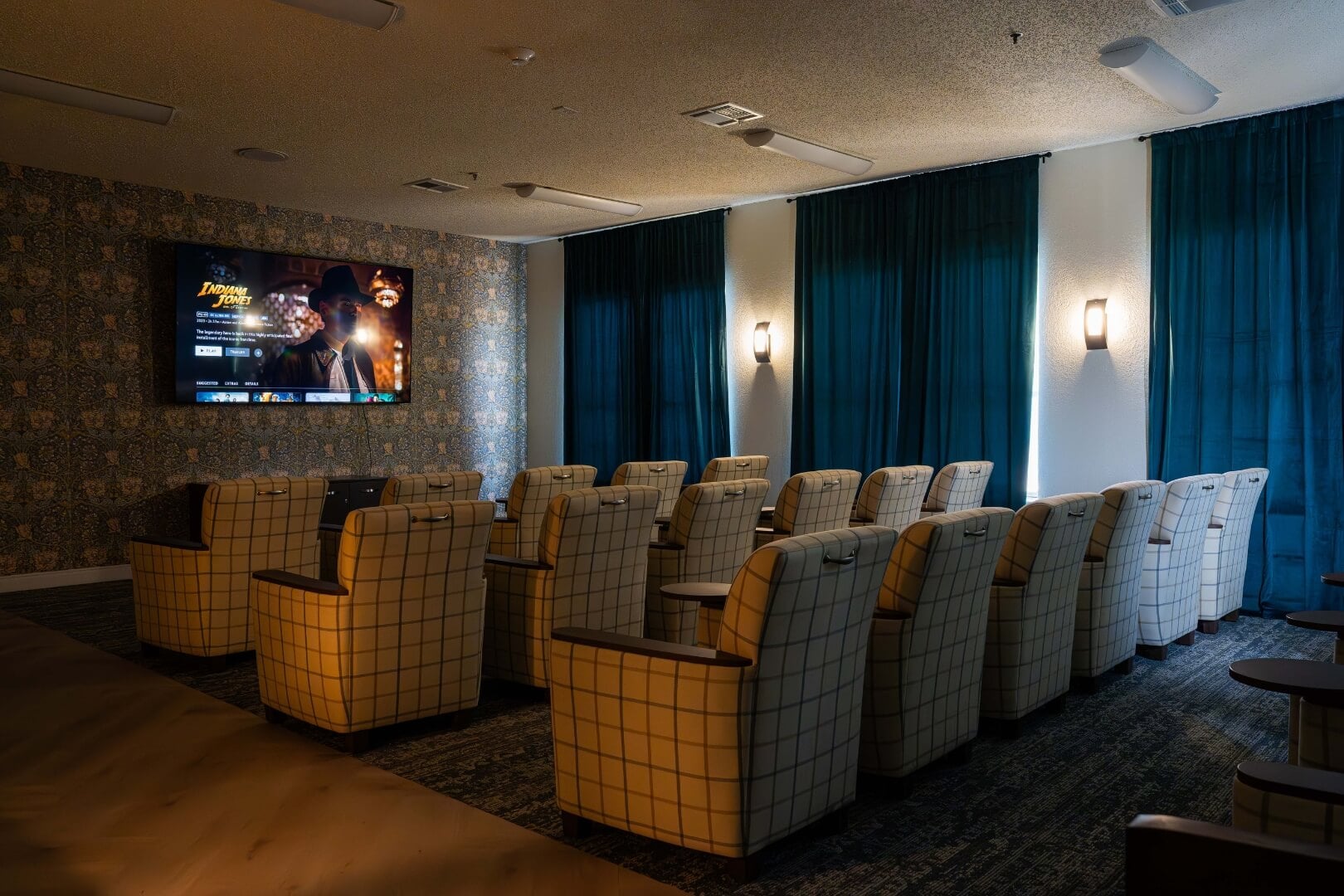Private Movie Theater With Plaid Seating at an Independent Living Facility