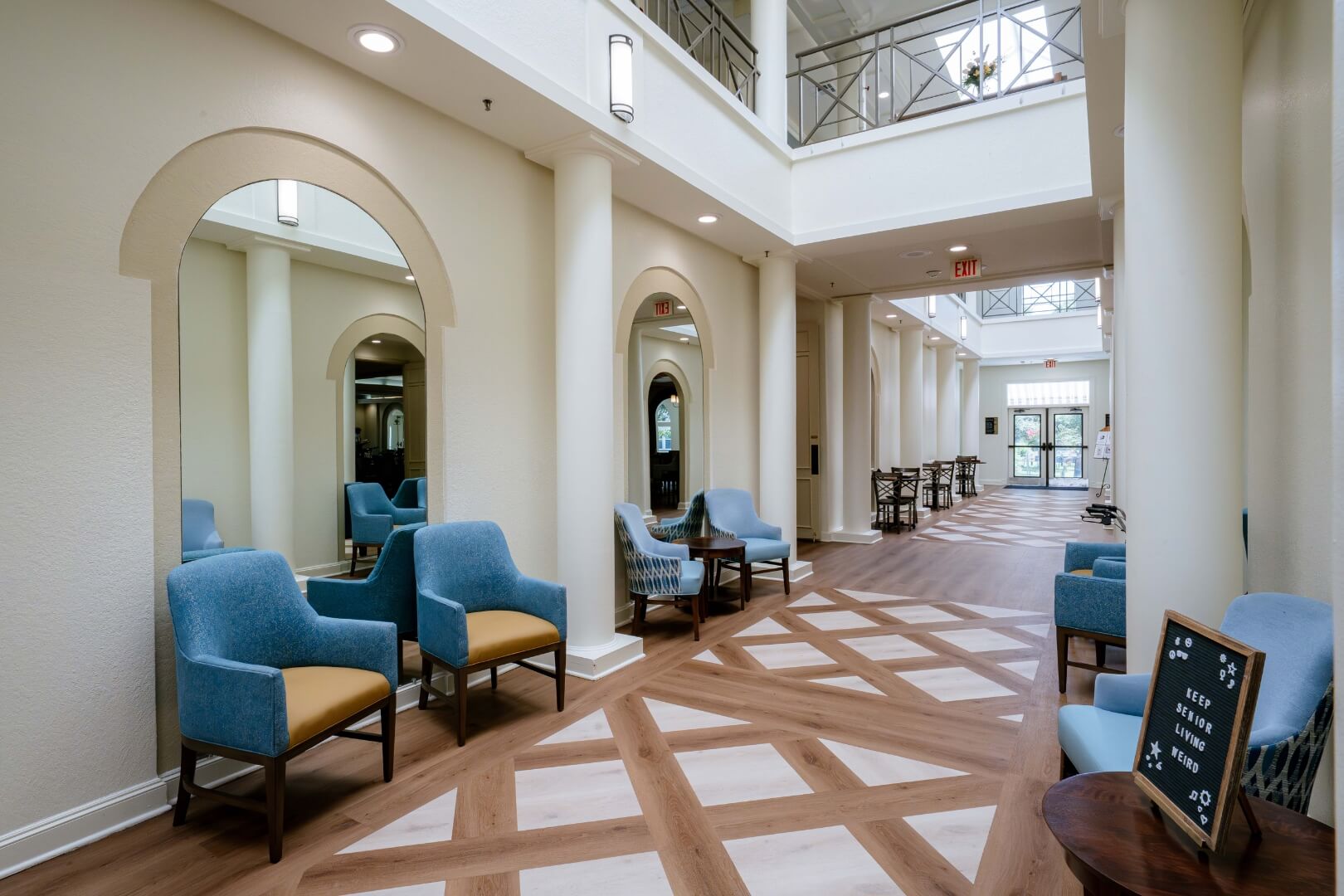 Bright Lobby With Arched Mirrors and Seating in an Independent Living Facility