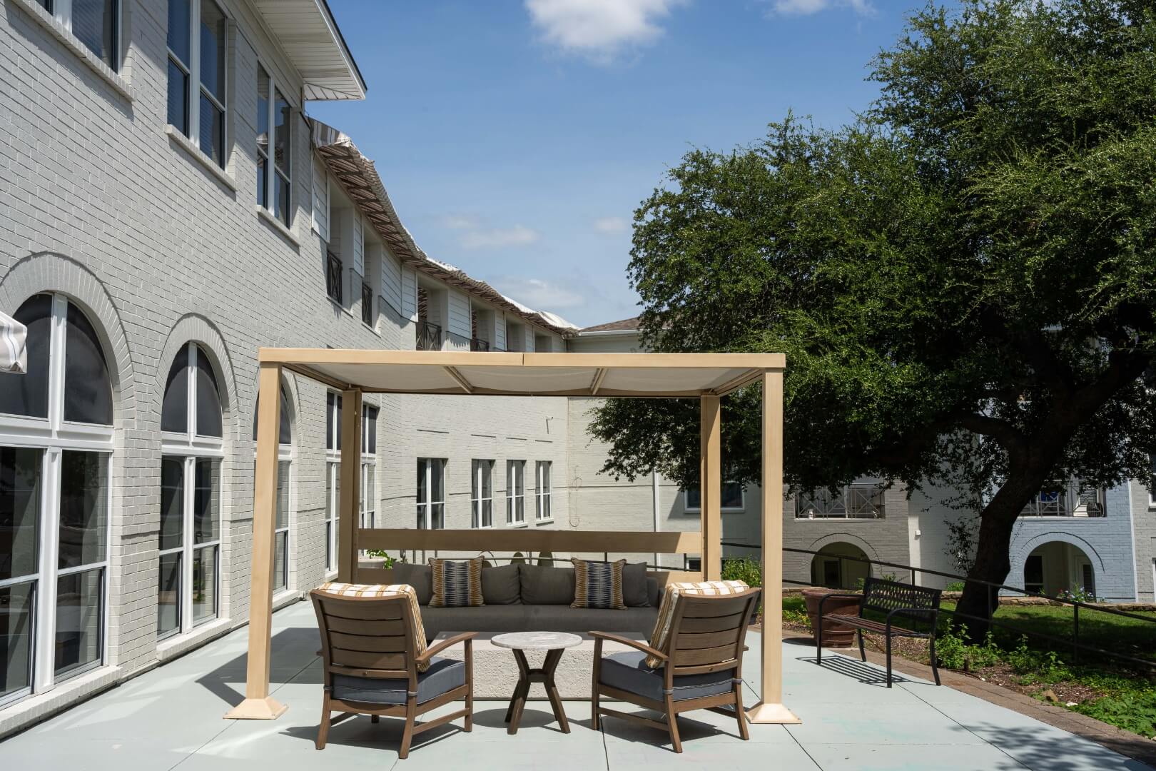 Shaded Pergola With Outdoor Seating at an Independent Living Facility