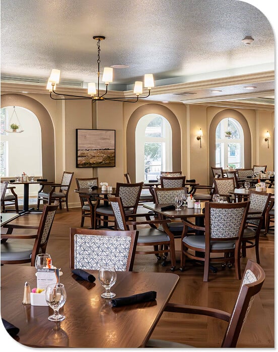Elegant Dining Hall with Chandeliers and Table Settings in Independent Living Community Elegant Dining Hall with Chandeliers and Table Settings in Independent Living Community