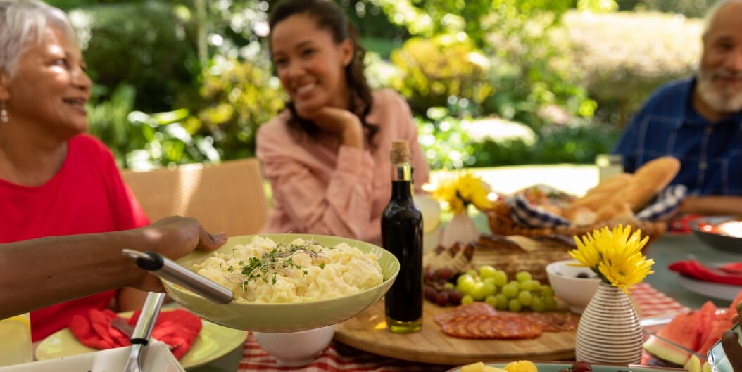 Elderly Residents Sharing Outdoor Meal at Independent Living Facility